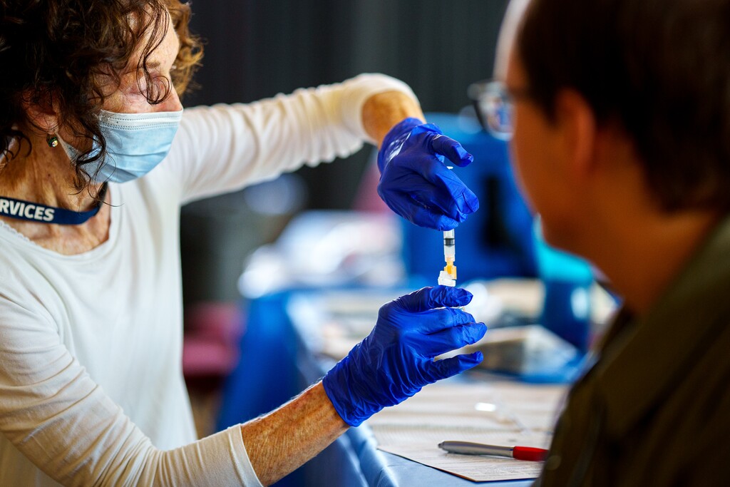 (Trent Nelson  |  The Salt Lake Tribune) Nurse Melanie Bills administers a COVID-19 vaccine to University of Utah student Eddie Overbay in Salt Lake City on Friday, Aug. 20, 2021.
