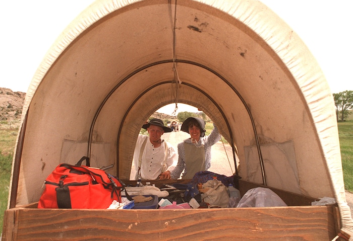 Rick Egan  | Tribune File Photo 

B C Moore and Amy Freestone push a handcart near Independence Rock, Wyoming.  The couple got engaged on the pioneer trail.   