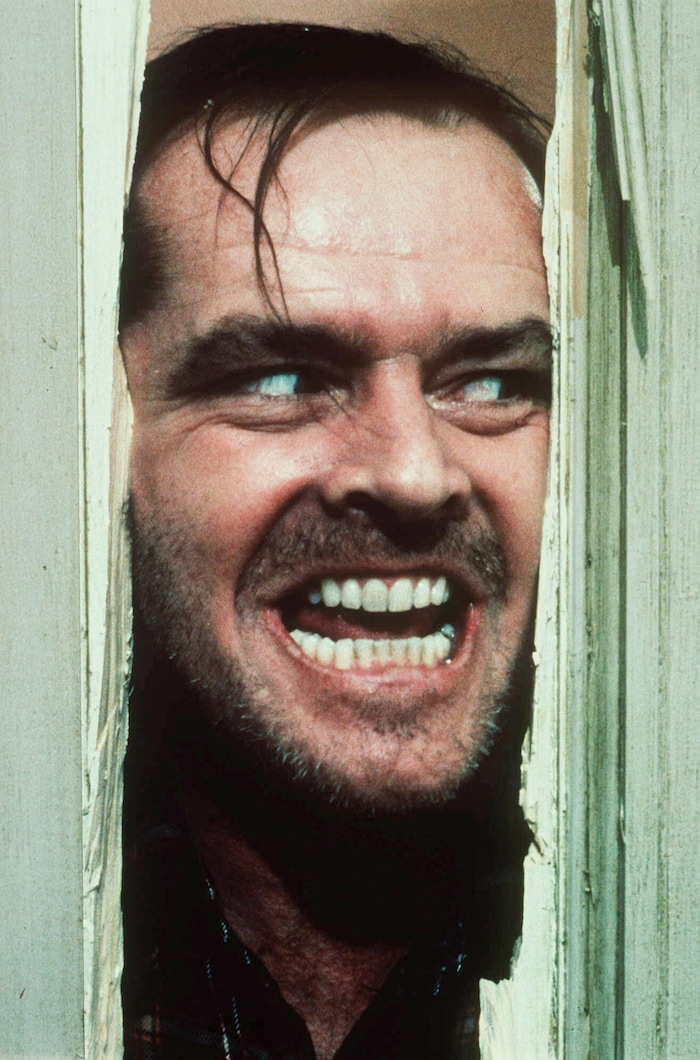 Jack Nicholson, portraying "Jack Torrance" in the movie "The Shining" directed by Stanley Kubrick, peers through a hole in a door, in this handout picture. (AP Photo/Warner Bros. Inc.)