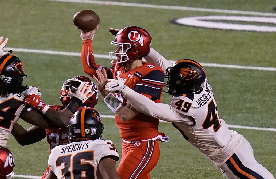 Oregon State linebacker Andrzej Hughes-Murray (49) hits Utah quarterback Jake Bentley (8) during the first half of an NCAA college football game Saturday, Dec. 5, 2020, in Salt Lake City. (AP Photo/Rick Bowmer)