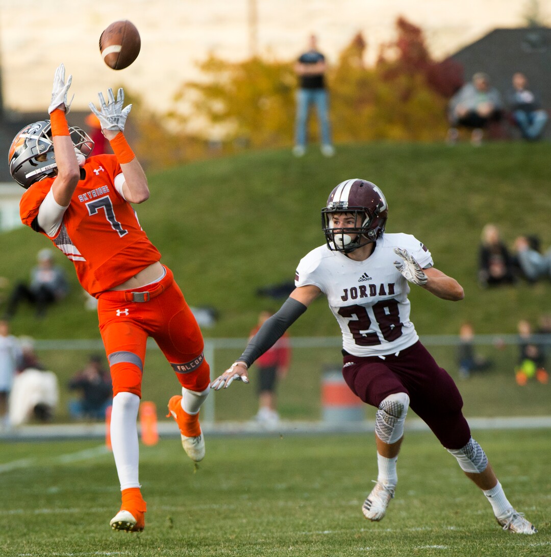 (Rick Egan  |  The Salt Lake Tribune)   Skyridge wide reciever Dylan Samuels catches a pass as Jordan High defensive back Alex Harston defends, in prep 5A playoff action, in Lehi, Friday, Nov. 2, 2018.