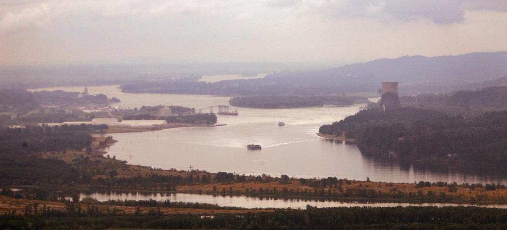 (Elaine Thompson | Associated Press file photo) In this May 12, 2005, file photo, ships move through the Columbia River looking south from near Longview, Wash. Six Western states — including Utah — and several national industry groups have lined up against Washington state in a legal battle over its decision to reject permits for a massive proposed coal-export terminal on the Columbia River.