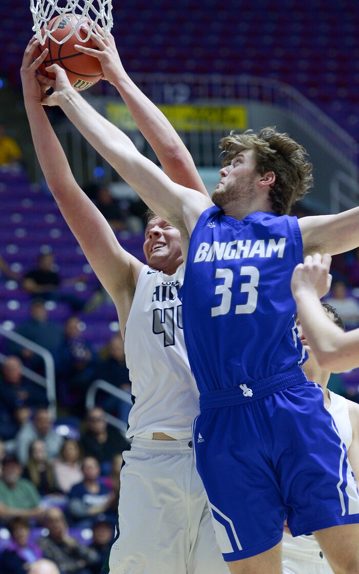 (Leah Hogsten  |  The Salt Lake Tribune) Copper Hills' Trevon Allfrey (44) battles Bingham's Kc Lewis (33) for the rebound. Copper Hills faces Bingham in the 6A High School Boys' Basketball Tournament opening game at Weber State University’s Dee Events Center in Ogden, Tuesday, Feb. 27, 2018. 
