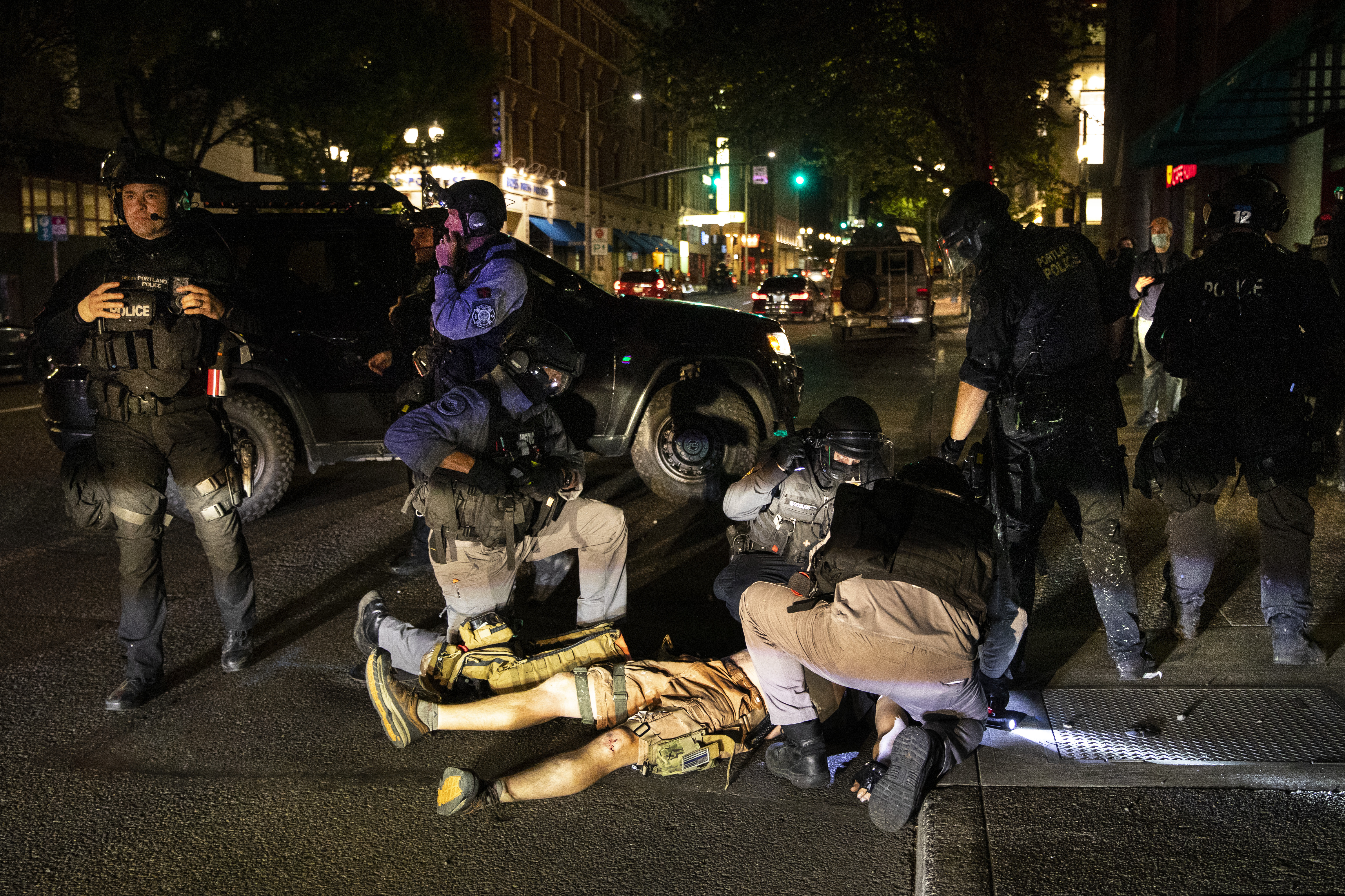 (Paula Bronstein | AP) A man is treated after being shot Saturday, Aug. 29, 2020, in Portland, Ore. It wasn’t clear if the fatal shooting late Saturday was linked to fights that broke out as a caravan of about 600 vehicles was confronted by counterdemonstrators in the city’s downtown.