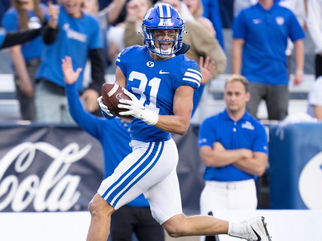 (Rick Egan | The Salt Lake Tribune) Brigham Young Cougars defensive back Dean Jones (21) runs for the end zone for. Touchdown, after intercepting a Aggie pass, in Football action between the Brigham Young Cougars and the Utah State Aggies, at LaVell Edwards Stadium in Provo, on Thursday, Sept. 29, 2022.