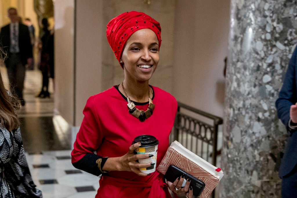 FILE - In this Jan. 16, 2019 file photo, Rep. Ilhan Omar, D-Minn., walks through the halls of the Capitol Building in Washington. In Omar's Minnesota district, both Jews and Muslims voiced concern about an inflammatory tweet on Israel that had the congresswoman apologizing within hours. While some Jews said she was being unfairly judged, some others said they feared she was being slow to learn from previous criticism. (AP Photo/Andrew Harnik, File)