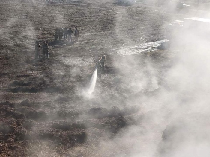 (Photo courtesy of the Juab County Fire District) Juab County Fire District crews spray water on a fire at the Young Living Lavender Farm in Mona. A compost pile of Pinyon juniper spontaneously combusted. Firefighters are using three water tenders to douse the smoldering material.