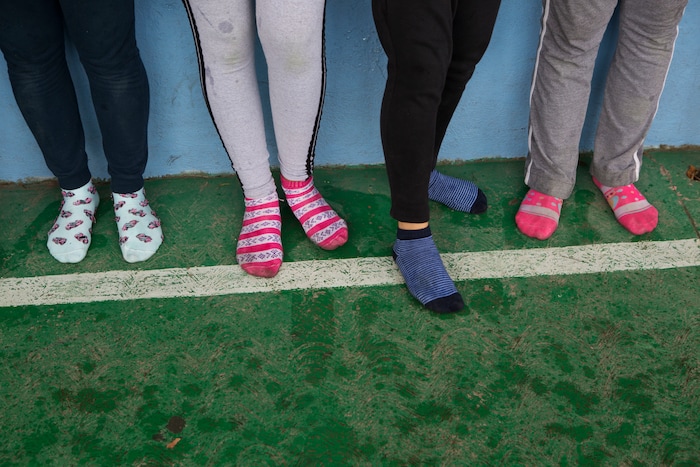 In this Aug. 25, 2017 photo, female nursing students stand in their socks as they take a self-defense workshop led by Muay Thai practitioners in Nezahualcoyotl, Mexico state. In Nezahualcoyotl, a group called Nos Queremos Vivas, or We Want to Stay Alive, sprung up after the murder of 11-year-old Valeria Gutierrez. It has organized marches and a self-defense workshop at a high school where 70 percent of the students are girls. (AP Photo/Rebecca Blackwell)
