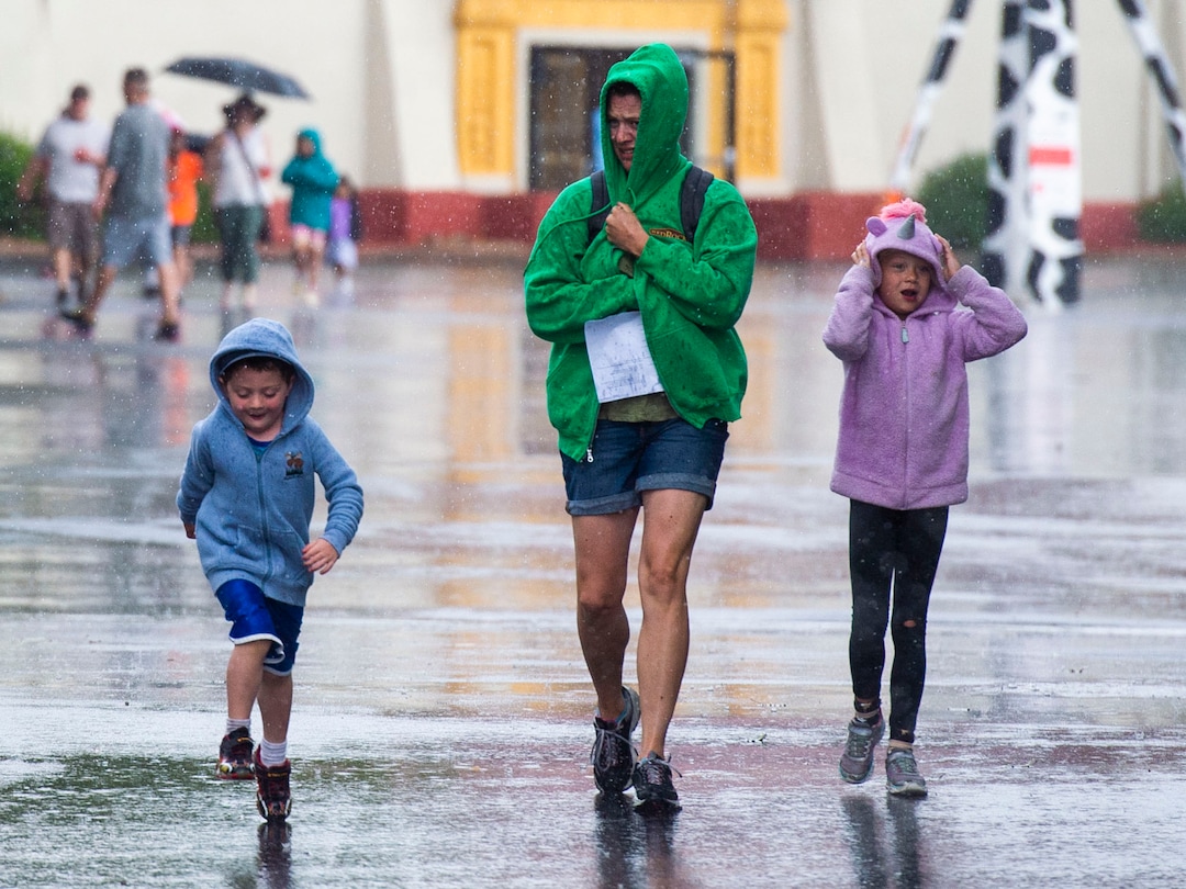 (Rick Egan  |  The Salt Lake Tribune)  Fair goers make their way to the next exhibit during a sudden rain storm, at the Utah State Fair, Sunday, Sept. 8, 2019.