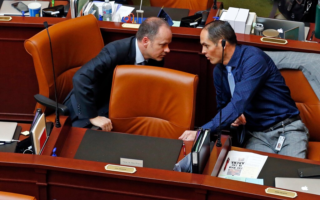 (Rick Bowmer | The Associated Press) In this Wednesday, Feb. 7, 2018, photo, Rep. Timothy D. Hawkes, R- Centerville, left, and Rep. Mike McKell, R-Spanish Fork, talk behind Rep. Jon Stanard's empty chair on the House floor at the Utah State Capitol, in Salt Lake City. Stanard has unexpectedly resigned from the Legislature. The Utah House of Representatives is investigating whether a lawmaker who abruptly resigned used a state-issued cellphone and hotel room paid for with taxpayer money to arrange trysts with a prostitute.