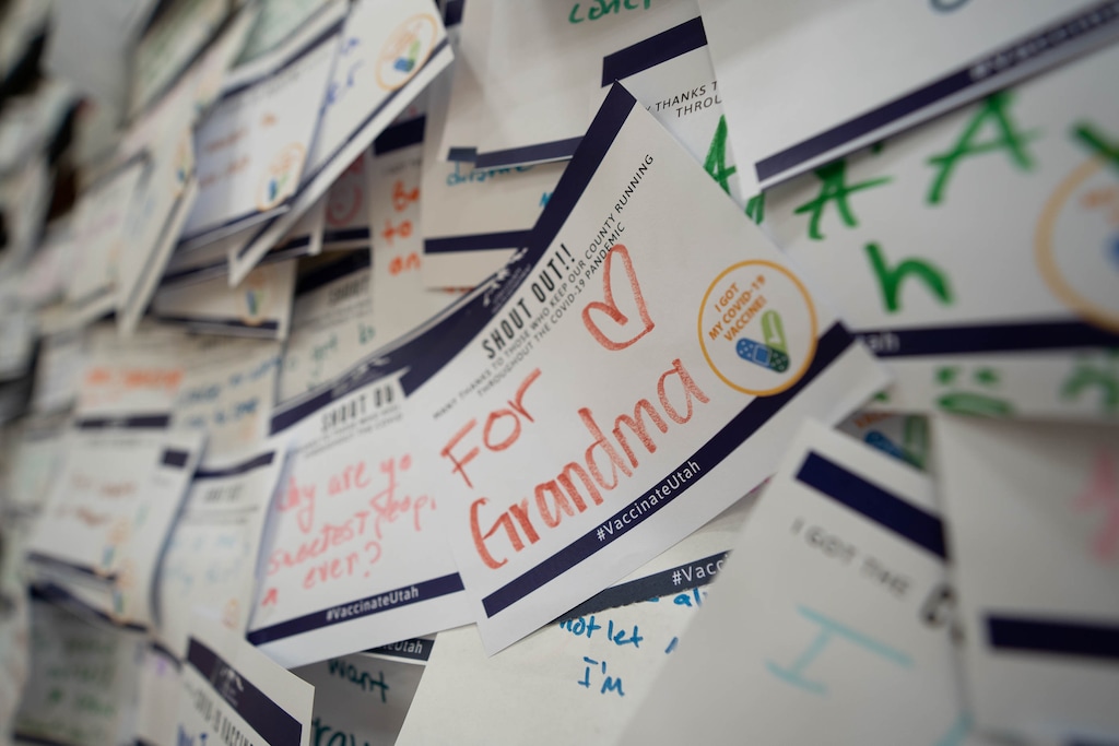 (Francisco Kjolseth | The Salt Lake Tribune) Folded-up bleachers at the old Provo High School gym are covered in notes accumulated since April by people giving their reasons for getting the COVID-19 vaccine as health care representatives administer the vaccine nearby on Wednesday, July 28, 2021.