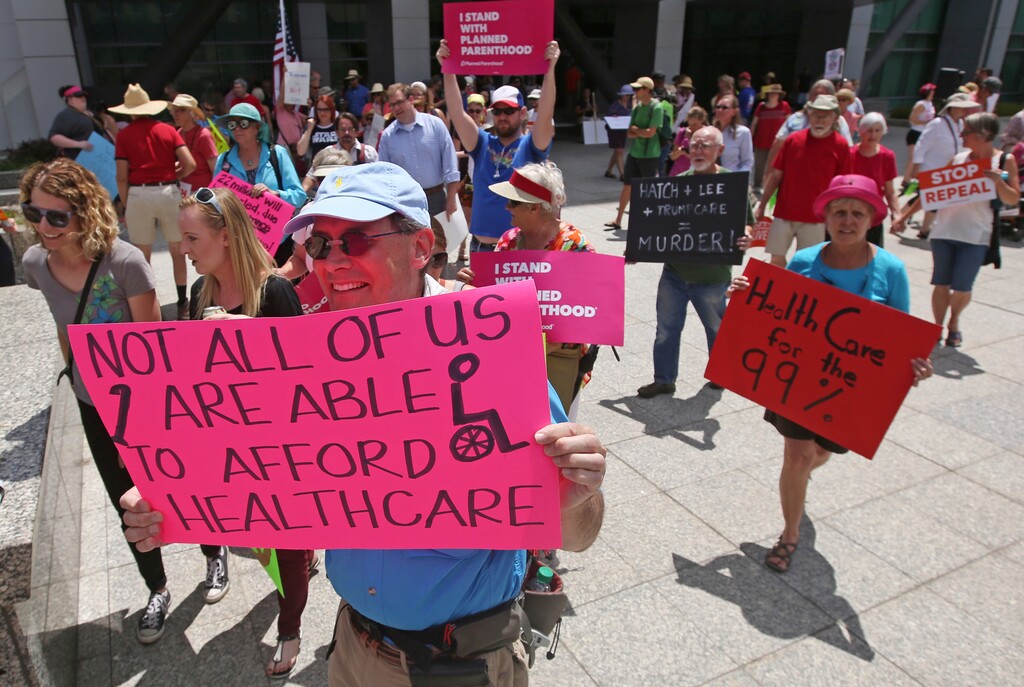 (Rick Bowmer | The Associated Press) In this June 27, 2017, file photo, people march during a protest against the Republican bill in the U.S. Senate to replace President Barack Obama's health care law, in Salt Lake City. Utah officials aren't making any changes to their plans to expand Medicaid and institute a work requirement, despite a federal judge halting a similar effort in Kentucky in June 2018. State Medicaid Director Nathan Checketts said Wednesday, July 11, 2018, the state was awaiting approval for its proposal from the federal government and wouldn't change course unless directed to do so.