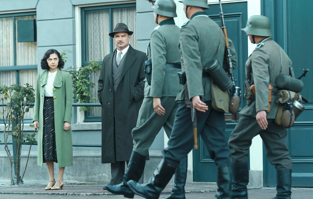 (Dusan Martincek | National Geographic for Disney) Miep Gies (Bel Powley) and Otto Frank (Liev Schreiber) watch as Nazi soldiers march down the street in Amsterdam in "A Small Light."