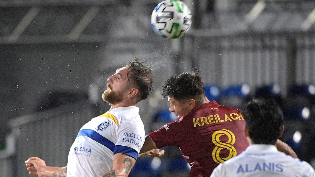 San Jose Earthquakes defender Guram Kashia, left, and Real Salt Lake midfielder Damir Kreilach (8) compete for a head ball during the first half of an MLS soccer match Monday, July 27, 2020, in Kissimmee, Fla. (AP Photo/Phelan M. Ebenhack)