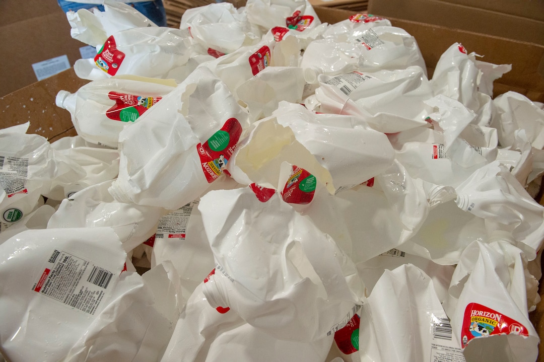 (Rick Egan  |  The Salt Lake Tribune)   Empty milk containers come out of the de-bottling machine at Wasatch Resource Recovery in North Salt Lake.  Friday, May 24, 2019.
