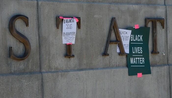 (Francisco Kjolseth  |  The Salt Lake Tribune) Protesters tape signs to the facade outside the Capitol building as part of rally against police brutality on Friday, June 26, 2020. Demonstrators removed the signs before leaving.
