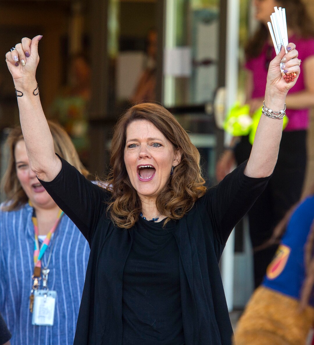(Rick Egan  |  The Salt Lake Tribune)         Jeri Rigby, the new principal of Copperview Elementary School, cheers for her teachers and their students as they walk the red carpet on the first day of school, Monday, Aug. 19, 2019.