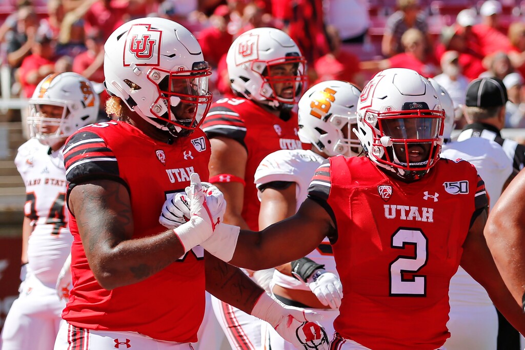Utah running back Zack Moss (2) celebrates with teammate Nick Ford, left, after scoring against Idaho State in the first half of an NCAA college football game Saturday, Sept. 14, 2019, in Salt Lake City. (AP Photo/Rick Bowmer)