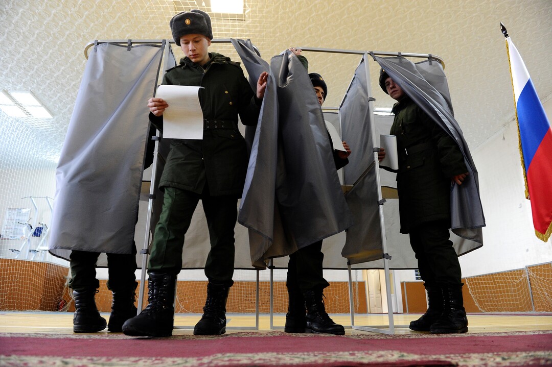 Russian soldiers exit a polling booth as they prepare to cast their ballots in the presidential election in Rostov-ojn-Don, Russia, Sunday, March 18, 2018. Russia's presidential election was tainted Sunday by unprecedented pressure on voters to turn out and incidents of suspected ballot box stuffing, a barely democratic exercise that will grant Vladimir Putin another six years of power. (AP Photo)