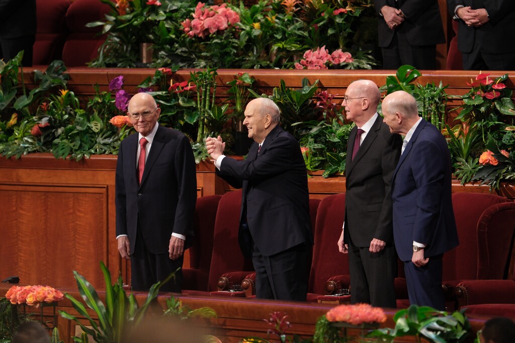 (The Church of Jesus Christ of Latter-day Saints) President Russell Nelson, center, reaches out to audience members at General Conference on Sunday, April 7, 2024.