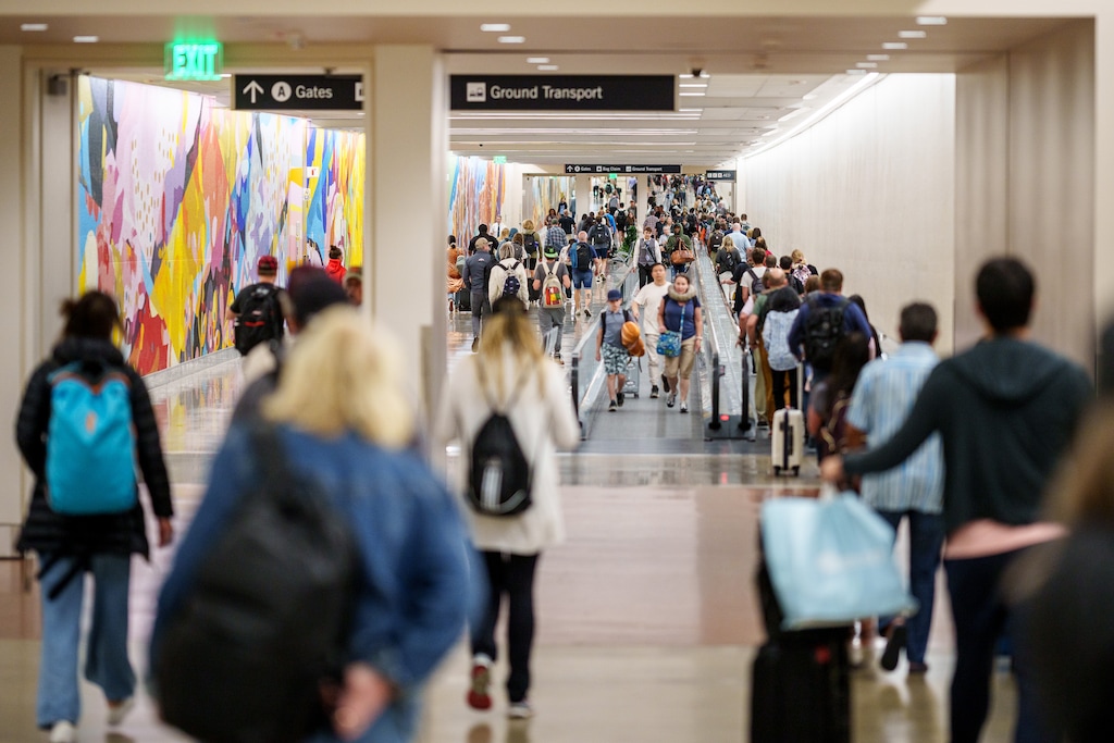 (Trent Nelson | The Salt Lake Tribune) Passengers walk between concourses at the Salt Lake City International Airport on Monday, June 19, 2023.
