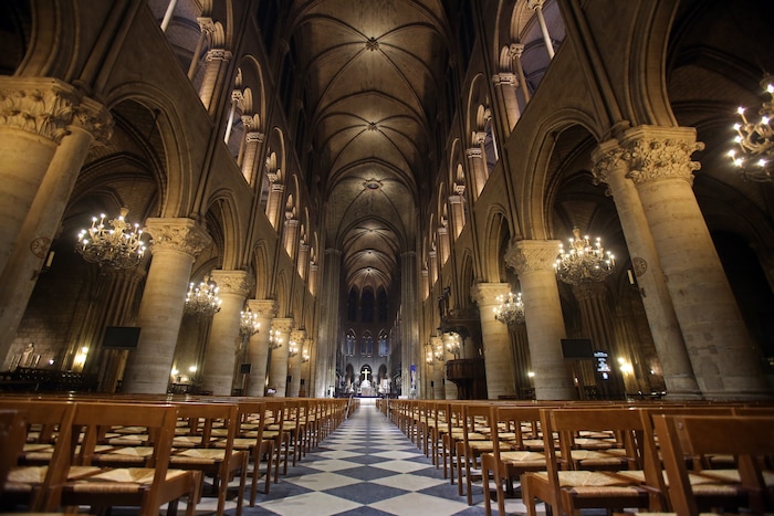 View of Notre Dame Cathedral in Paris with its new interior lighting presented Tuesday March 11, 2014. The new lighting design at the Notre-Dame cathedral is made of lead fixtures to highlight the XIIth century monument. Around 14 million people visit the Cathedral each year. (AP Photo / Remy de la Mauviniere)  