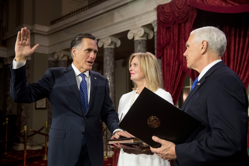 Vice President Mike Pence administers the Senate oath of office to Sen. Mitt Romney, R-Utah, accompanied by his wife Ann, during a mock swearing in ceremony in the Old Senate Chamber on Capitol Hill in Washington, Thursday, Jan. 3, 2019, as the 116th Congress begins. (AP Photo/Andrew Harnik)