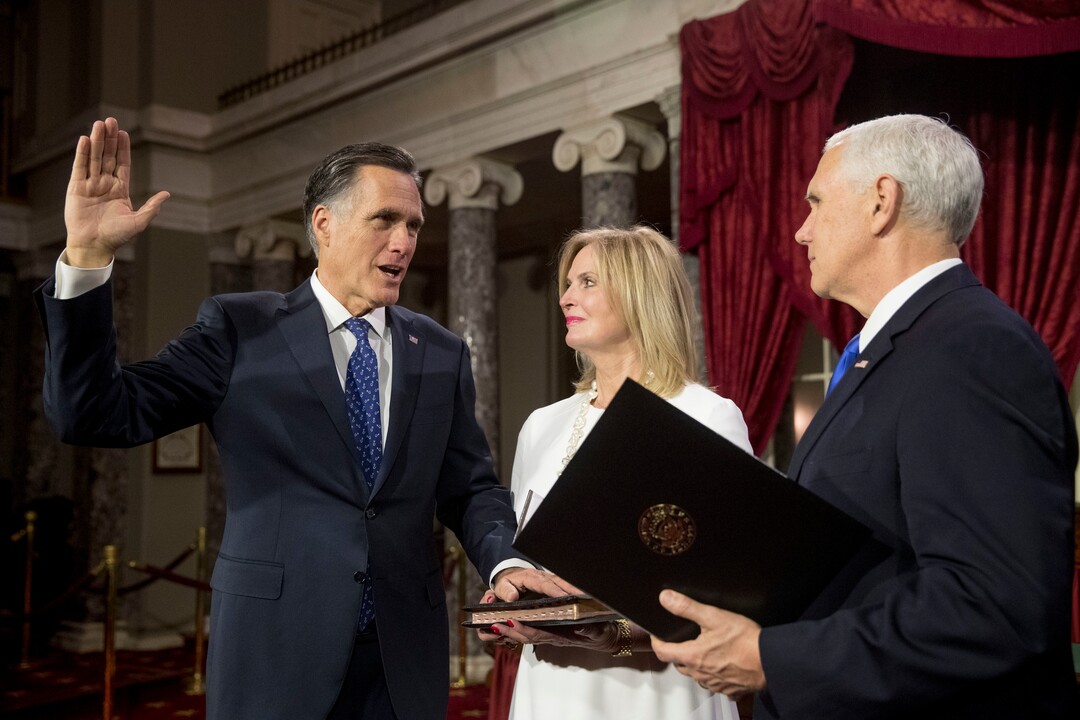Vice President Mike Pence administers the Senate oath of office to Sen. Mitt Romney, R-Utah, accompanied by his wife Ann, during a mock swearing in ceremony in the Old Senate Chamber on Capitol Hill in Washington, Thursday, Jan. 3, 2019, as the 116th Congress begins. (AP Photo/Andrew Harnik)