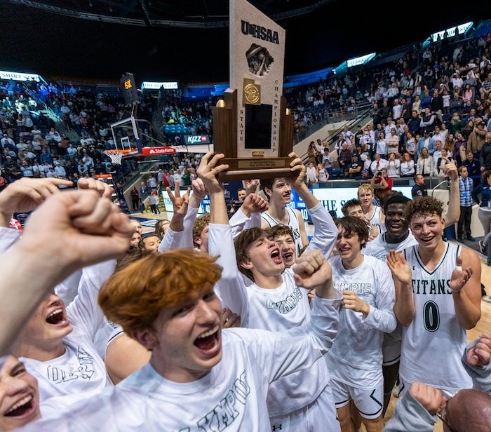 (Rick Egan | The Salt Lake Tribune) the Olympus titans celebrate their win in the 5A State Championship game between Woods Cross and Olympus, at the Marriott Center in Provo, on Saturday, March 5, 2022. 