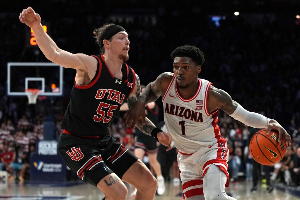 (Rick Scuteri | AP) Arizona guard Caleb Love (1) drives on Utah guard Gabe Madsen during the second half of an NCAA college basketball game, Wednesday, Feb. 26, 2025, in Tucson, Ariz.