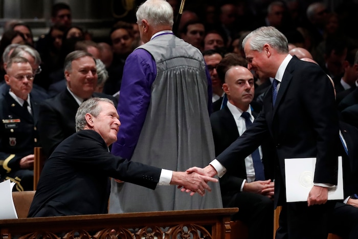 Presidential biographer Jon Meacham, shakes hands with former President George Bush after speaking during the State Funeral for former President George H.W. Bush at the National Cathedral, Wednesday, Dec. 5, 2018, in Washington.(AP Photo/Alex Brandon, Pool)