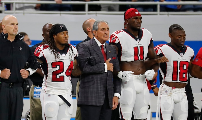 Atlanta Falcons owner Arthur Blank stands with his players during the national anthem before an NFL football game against the Detroit Lions, Sunday, Sept. 24, 2017, in Detroit. (AP Photo/Rick Osentoski)