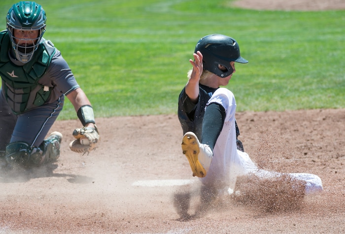 (Rick Egan  |  The Salt Lake Tribune)   Jordan High starts their celebration as Ricky Medina scores the 11th run of the game, as Jordan defeats Olympus their 11-1, for the 5A state baseball championship, at UVU in Orem, Friday, May 25, 2018.