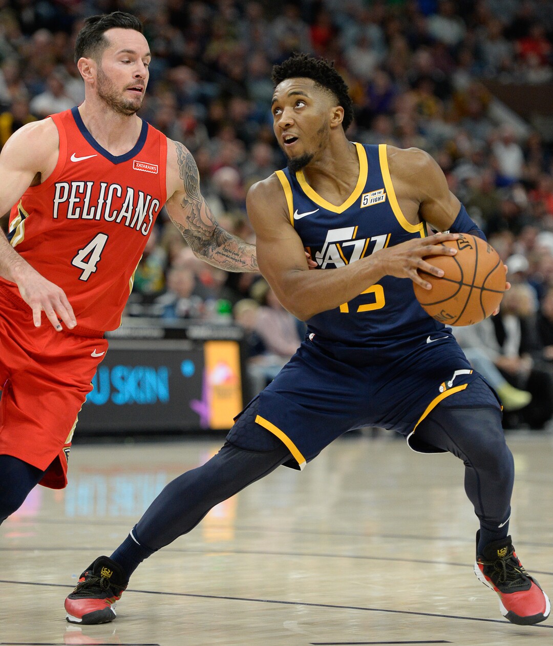 (Francisco Kjolseth  |  The Salt Lake Tribune)  Utah Jazz guard Donovan Mitchell (45) fakes New Orleans Pelicans guard JJ Redick (4) as the Utah Jazz host the New Orleans Pelicans in their NBA basketball game at Vivint Smart Home Arena in Salt Lake City on Sat. Nov. 23, 2019.