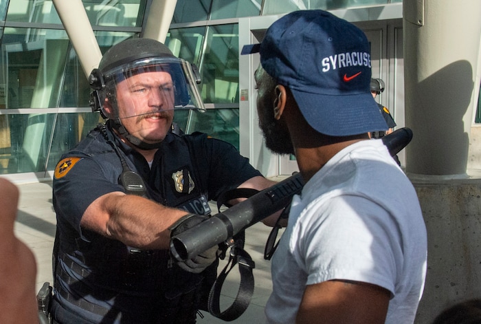 (Rick Egan  |  The Salt Lake Tribune)      A Salt Lake City Policeman reacts as a protester gets a little too close, at the Public Safety Building, during a demonstration, Monday, June 1, 2020.


