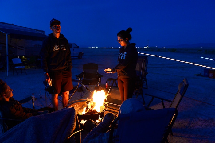 (Scott Sommerdorf | The Salt Lake Tribune)
Volunteers at Aid Station 14 warm themselves around a fire at the Salt Flats 100 Endurance Run, Saturday, May 5, 2018.
