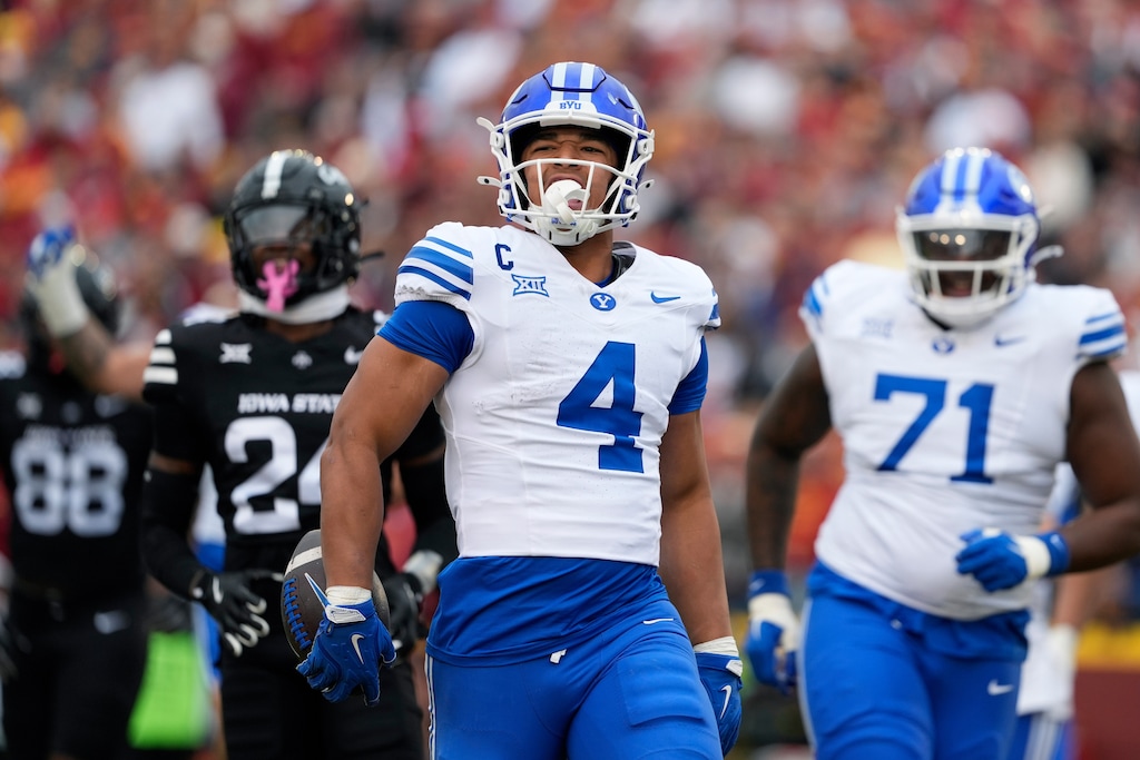 (Matthew Putney | AP) BYU running back LJ Martin (4) runs in a touchdown against Iowa State during the first half of an NCAA college football game, Saturday, Oct. 25, 2025, in Ames, Iowa.