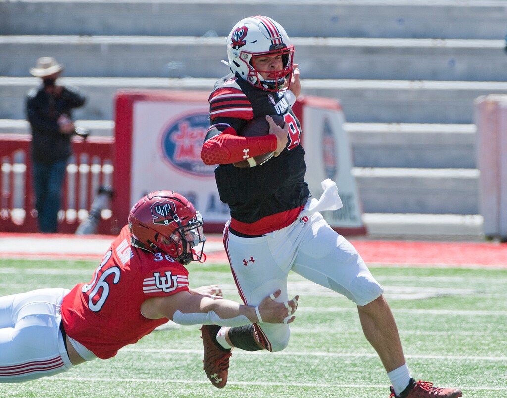 (Ed Kosmicki | Special to The Tribune) The red team linebacker Chris Wilson gets a grip on black team's Peter Costelli #8 during the annual spring football game at the University of Utah, 17 April 2021. 