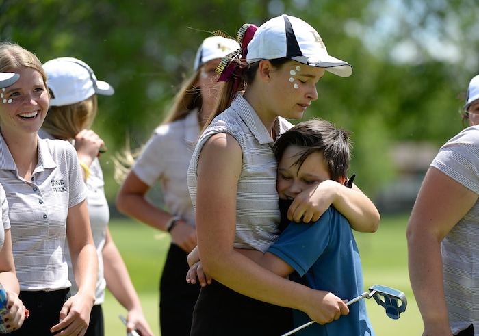 (Francisco Kjolseth  |  The Salt Lake Tribune)  Lauren Taylor of Lone Peak is comforted by her brother Logan, 10, after losing the individual title to Bingham by one stroke on day two of the Class 6A girls' golf state tournament at Meadow Brook Golf Course in Taylorsville on Tuesday, May 15, 2018. Despite her individual loss to Tess Blair of Bingham, Taylor propelled her team to a first place finish. 