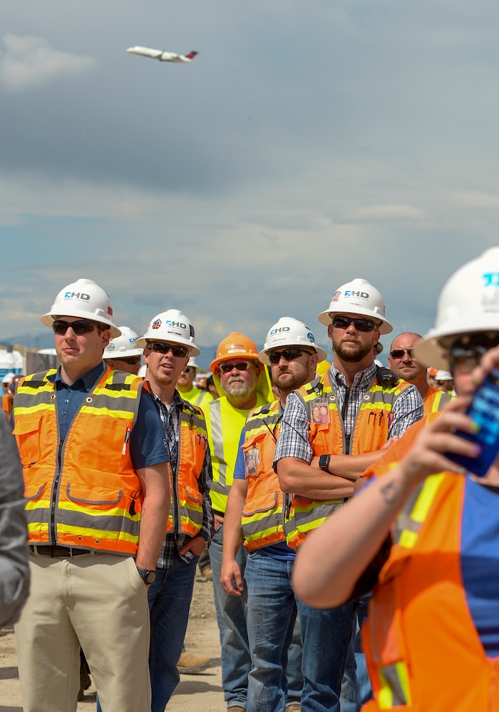 (Leah Hogsten  |  The Salt Lake Tribune) Construction workers from various trades celebrate the last steel beam on the new $485 million, 866,087 square foot, Salt Lake City International terminal building, Wednesday, May 23, 2018.