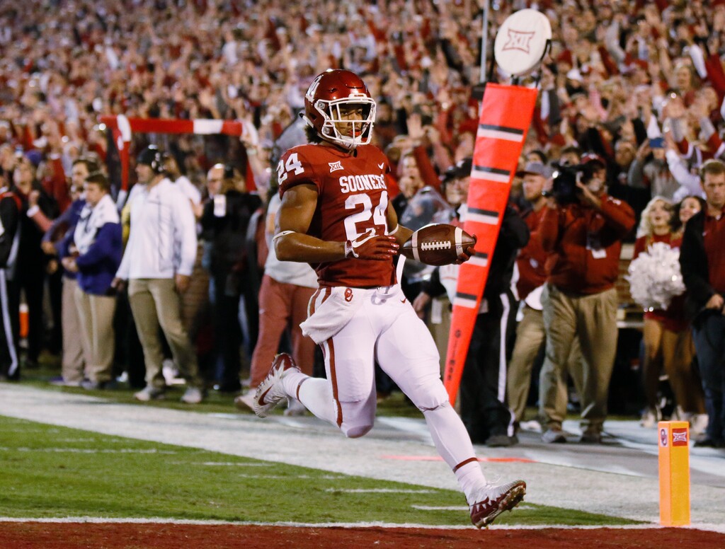 Oklahoma running back Rodney Anderson (24) runs into the end zone for a touchdown in the first quarter of an NCAA college football game against TCU in Norman, Okla., Saturday, Nov. 11, 2017. (AP Photo/Sue Ogrocki)