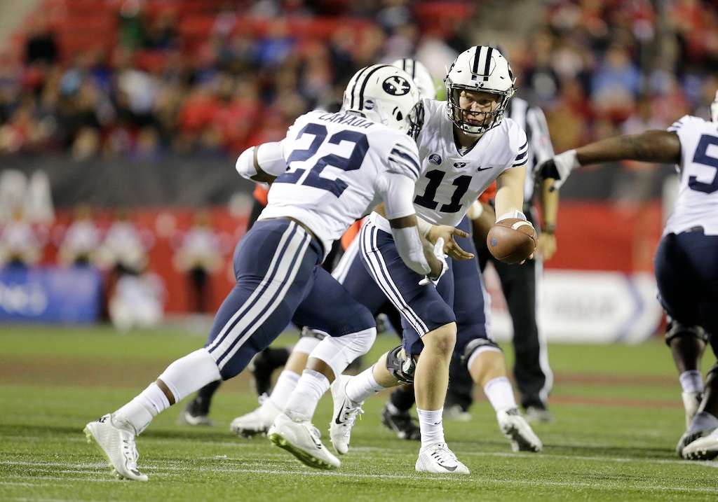 LAS VEGAS, NV - NOVEMBER 10: BYU quarterback Joe Critchlow (11) hands the football off to BYU running back Squally Canada (22) during a game against UNLV on November 11, 2017, at Sam Boyd Stadium in Las Vegas, Nevada.  The BYU Cougars would defeat the UNLV Rebels 31-21.  (Photo by Marc Sanchez/Icon Sportswire) (Icon Sportswire via AP Images)