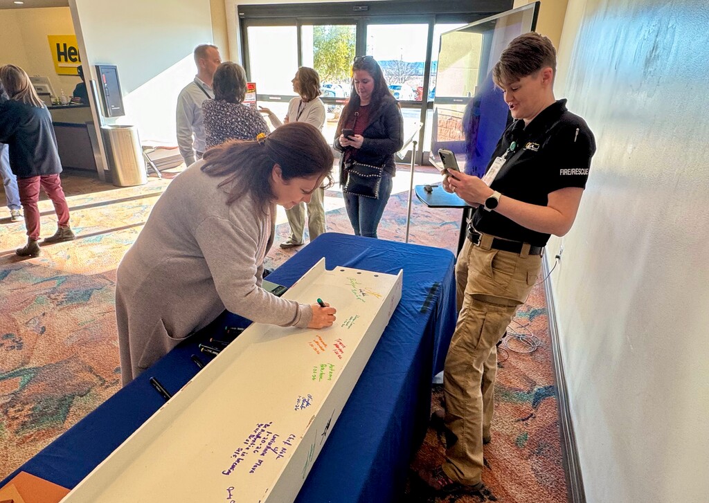 (Mark Eddington | The Salt Lake Tribune) St. George resident Rachel Kidman writes her signature during a beam-signing ceremony for a new airport control tower for the St. George Regional Airport on Tuesday, Jan. 20, 2026.
