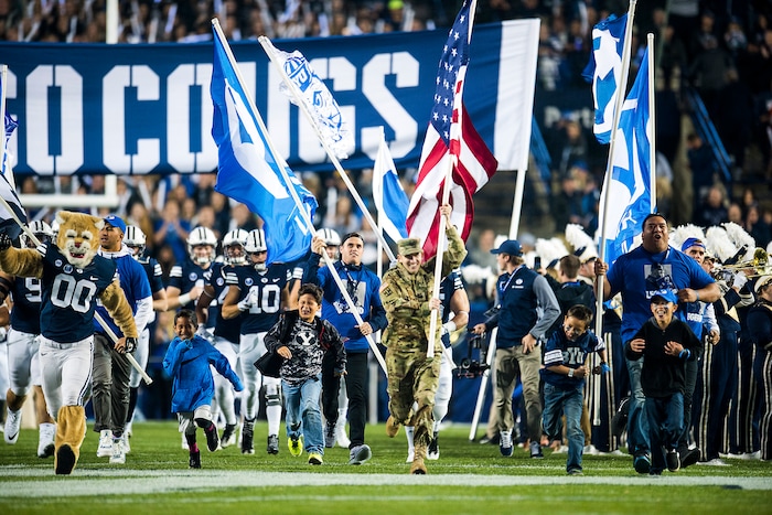 (Chris Detrick  |  The Salt Lake Tribune)  Brigham Young Cougars and fans run onto the field before the game LaVell Edwards Stadium Friday, October 6, 2017. 