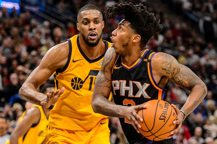 (Trent Nelson | The Salt Lake Tribune)  Phoenix Suns guard Elfrid Payton (2) drives on Utah Jazz forward Derrick Favors (15) as the Utah Jazz host the Phoenix Suns, NBA basketball in Salt Lake City, Wednesday Feb. 14, 2018.