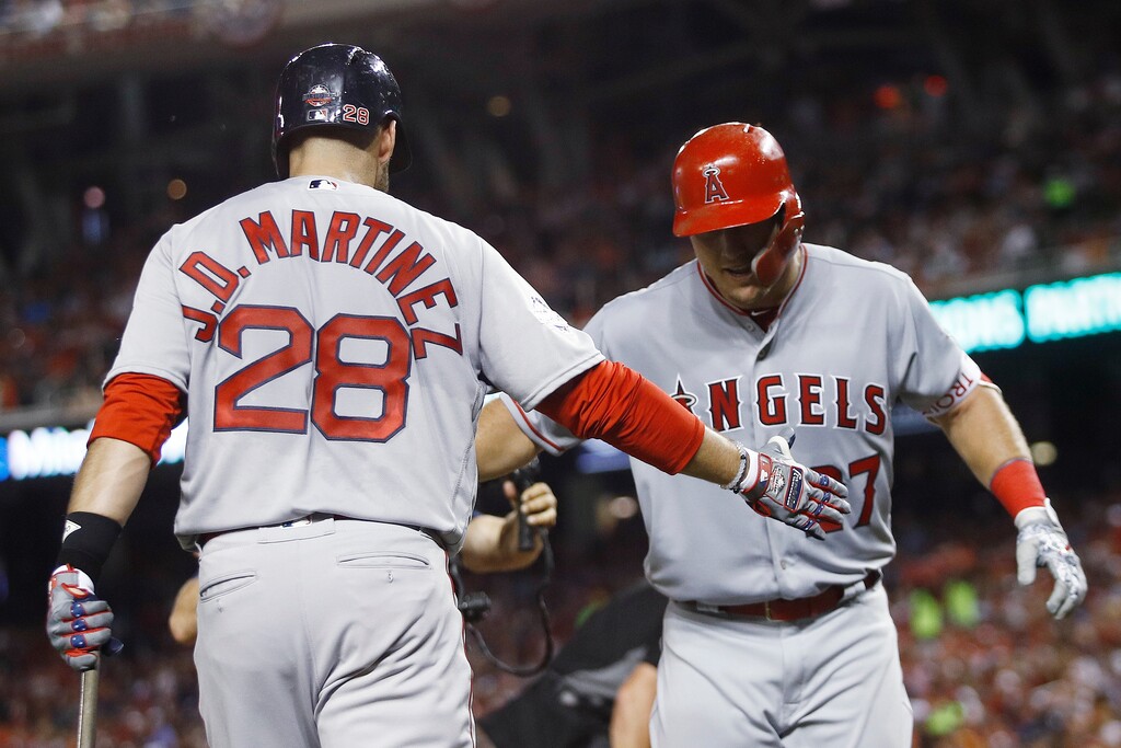 Los Angeles Angels of Anaheim outfielder Mike Trout (27) is welcomed at the dugout by Boston Red Sox's J.D. Martinez (28) after his solo home run during the third inning of the Major League Baseball All-Star Game, Tuesday, July 17, 2018, in Washington. (AP Photo/Patrick Semansky)