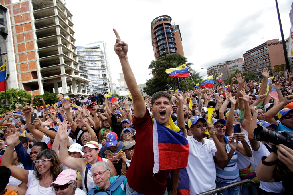(Boris Vergara | The Associated Press) Anti-government protesters cheer after Juan Guaido, head of Venezuela's opposition-run congress, declares himself interim president of the South American country until a new election can be called, at a rally demanding the resignation of President Nicolas Maduro, in Caracas, Venezuela, Wednesday, Jan. 23, 2019.