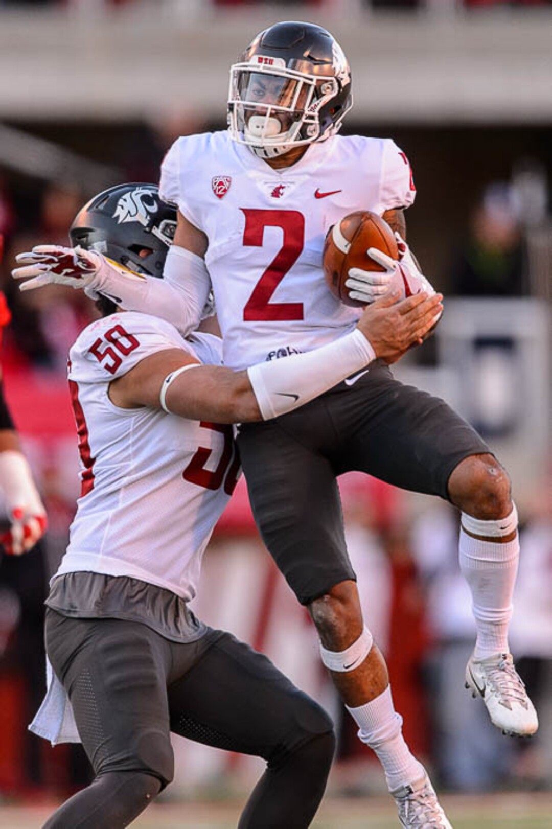 (Trent Nelson | The Salt Lake Tribune)  Washington State Cougars defensive back Robert Taylor (2) celebrates an interception with teammate Washington State Cougars defensive lineman Hercules Mata'afa (50) as the University of Utah hosts Washington State, NCAA football in Salt Lake City, Saturday November 11, 2017.