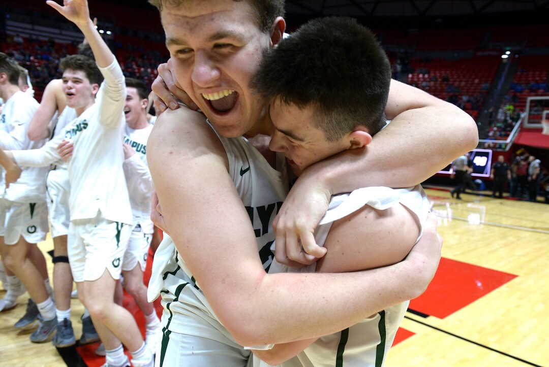 (Leah Hogsten  |  The Salt Lake Tribune) Olympus' Harrison Creer (23) hugs Rylan Jones (15). Olympus defeated Corner Canyon 76-49 to win the 5A High School Boys’ Basketball Tournament Championship at the Jon M. Huntsman Center in Salt Lake City,  Saturday, March 3, 2018. 