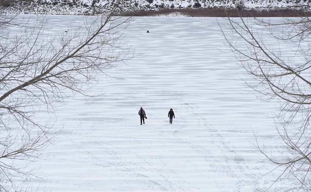 (Francisco Kjolseth  |  The Salt Lake Tribune)  Ice fisherman walk the ice at Echo Reservoir in Summit County next to Coalville which could become a state park.